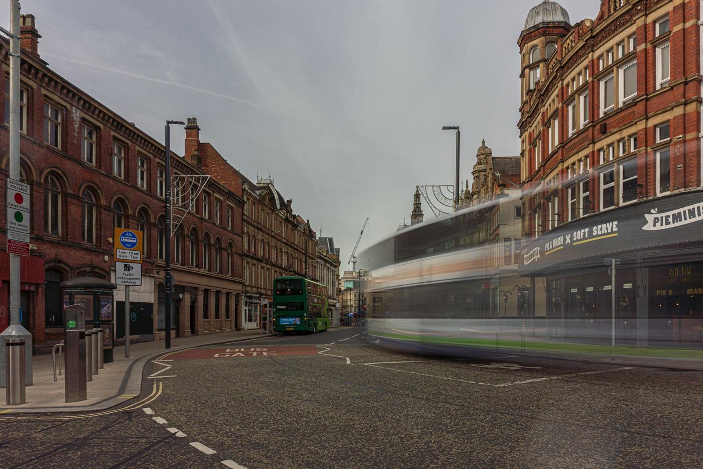 Leeds city centre street with a tram and Victorian buildings