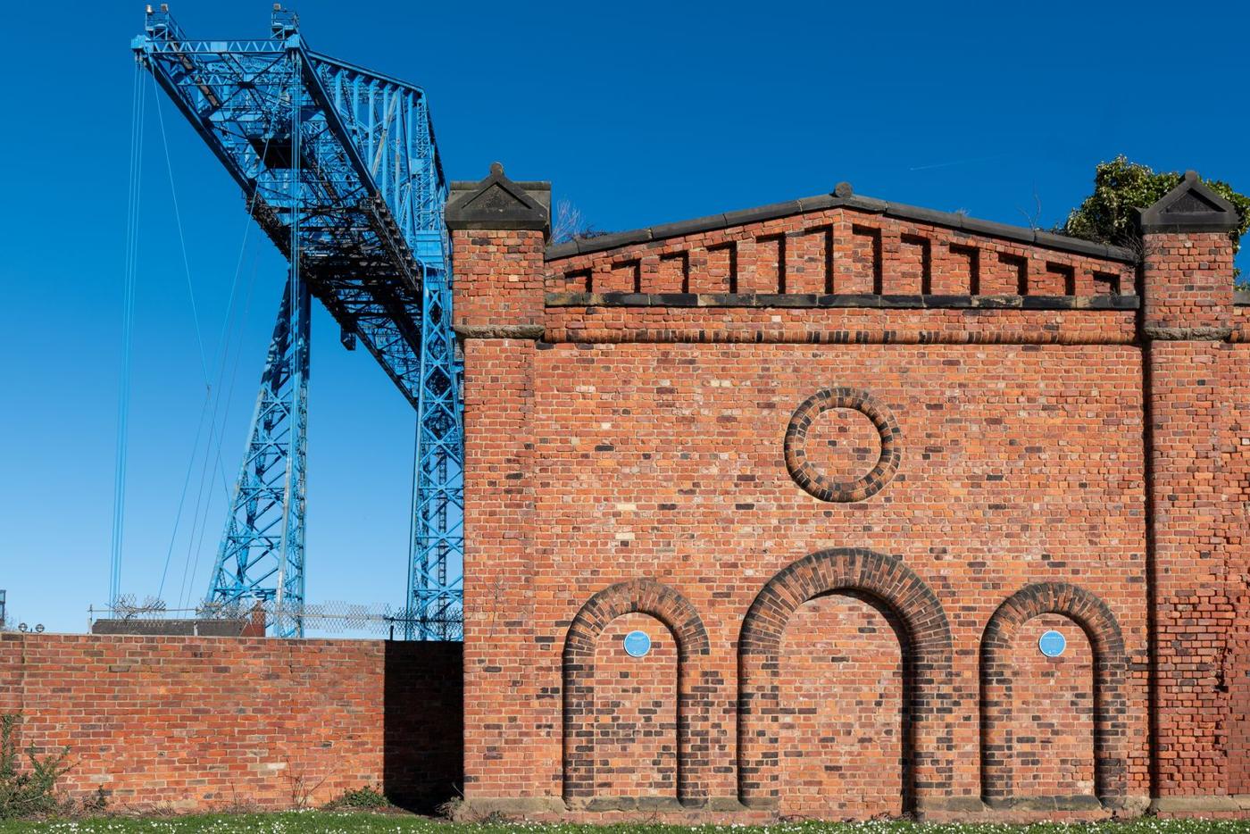 The Transporter Bridge beside the brick Transporter building in Middlesbrough